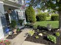 Inviting front yard with lush landscaping, a charming walkway, and a welcoming entrance at 12458 Trumbull Ct, Fishers, IN 46038