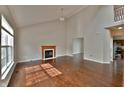 Spacious living room with wood floors, fireplace, and ample natural light at 14538 Baldwin Ln, Carmel, IN 46032