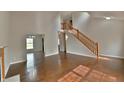 Open-concept living room featuring hardwood floors and staircase to the second level at 14538 Baldwin Ln, Carmel, IN 46032