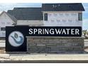 Springwater community sign with stone base, set against backdrop of new construction at 16387 Burlwood Dr, Westfield, IN 46074