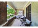 Relaxing front porch with outdoor seating, brick pillars, and string lights at 1826 N Alabama St, Indianapolis, IN 46202