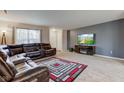Spacious living room featuring a sectional sofa, neutral carpeting, and a modern entertainment center at 1839 Silverton Dr, Avon, IN 46123