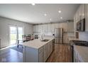 Bright kitchen featuring white cabinetry, stainless steel appliances, and a large center island at 2237 S Copperstone Dr, New Palestine, IN 46163