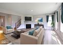 A cozy living room with a fireplace, hardwood floors, and stylish furnishings at 2237 S Copperstone Dr, New Palestine, IN 46163
