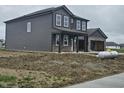 Two-story house with gray siding and brick accents on a partially landscaped lot at 2249 Oakmont Dr, Plainfield, IN 46168