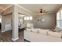 Spacious living area flowing into the dining room, featuring a ceiling fan and a large window at 2325 Silver Rose Dr, Avon, IN 46123