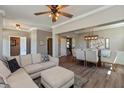 Open-concept living and dining area with wood floors, featuring a comfortable sofa and stylish dining set at 2325 Silver Rose Dr, Avon, IN 46123