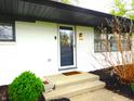 Welcoming front entrance to home showcasing a black front door, and landscaped steps at 2416 Depauw Rd, Indianapolis, IN 46227