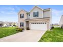Well-maintained two-story home featuring a two-car garage and lush green lawn at 2681 Pumpkin Patch Ln, Indianapolis, IN 46229