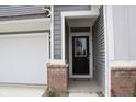 Close-up of the front door with brick accents and the house number '2704' at 2704 Grassy Br Dr, Whitestown, IN 46075