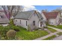 Beautifully maintained home with lush lawn, landscaped garden, and classic architectural details at 304 W 4Th St, Greenfield, IN 46140