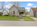 Charming two-story home featuring a well-manicured lawn, inviting front porch, and classic architectural details at 304 W 4Th St, Greenfield, IN 46140