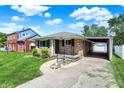 Quaint brick home with a covered carport and manicured lawn at 3809 Wildwood Dr, Indianapolis, IN 46239