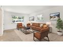 Bright living room features a comfortable brown couch and ample natural light at 3809 Wildwood Dr, Indianapolis, IN 46239