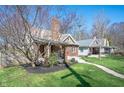 Charming brick home with a well-maintained lawn and inviting front porch at 4102 N Illinois St, Indianapolis, IN 46208