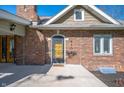 Close up of front door and brick exterior with garden bed and walkway at 4102 N Illinois St, Indianapolis, IN 46208