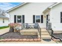 Inviting front porch with chairs and a small table, perfect for relaxing and enjoying the outdoors at 438 N 11Th Ave, Beech Grove, IN 46107