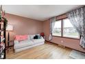 Bright living room with a large window, comfortable seating, and hardwood floors, creating a welcoming space at 438 N 11Th Ave, Beech Grove, IN 46107