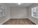 This bedroom features hardwood floors, natural light, and neutral walls at 4618 W Beecher St, Indianapolis, IN 46241