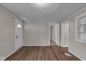Neutral living room with hardwood floors, a white front door and several entryways at 4618 W Beecher St, Indianapolis, IN 46241