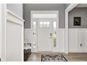 Inviting foyer with wainscoting, stylish light fixtures, and a front door with sidelights at 4644 Shelby Cir, Greenwood, IN 46143