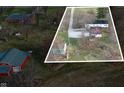 An aerial of a home and garage on a large property, surrounded by other properties and bare trees at 4653 E Us Highway 36, Markleville, IN 46056