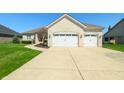 This home features a three-car garage and a well-maintained yard at 4858 Brentridge Pl, Greenwood, IN 46143