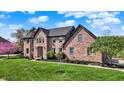 Attractive brick home with a well-manicured lawn and garden beds at 4932 Willow Ridge Ct, Zionsville, IN 46077