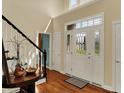 Inviting foyer with a beautiful front door, hardwood floors, and stairway at 4932 Willow Ridge Ct, Zionsville, IN 46077