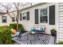 Cozy outdoor seating area with stylish patterned rug and colorful cushions on the front porch at 5140 Indianola Ave, Indianapolis, IN 46205