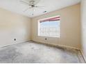 Bedroom featuring a window with blinds, electrical outlets, and a ceiling fan at 5213 Milhouse Rd, Indianapolis, IN 46221