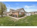 Well-maintained exterior featuring lush landscaping, a brick facade, and a cozy fenced patio for outdoor enjoyment at 5324 Rolling Meadow Blvd, Indianapolis, IN 46237