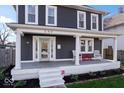 Close-up of the home's charming front porch with decorative pillars and inviting seating at 549 Keystone Ave, Indianapolis, IN 46201