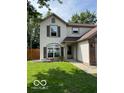 Beautiful two-story home with a well-manicured lawn, arched window, and neutral siding, creating an inviting facade at 563 Jet Stream Blvd, Westfield, IN 46074