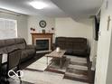 Cozy living room featuring a fireplace, plush couches, a decorative rug, and modern decor, perfect for relaxing at 563 Jet Stream Blvd, Westfield, IN 46074