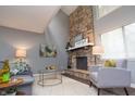 Living room with a stone fireplace, neutral decor, and ample natural light at 5713 Bradston Way, Indianapolis, IN 46237