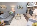 Cozy living room featuring a stone fireplace and modern furnishings at 5713 Bradston Way, Indianapolis, IN 46237