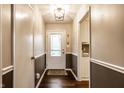 Welcoming entryway features hardwood floors, two-tone paint, a decorative light fixture and a glass paneled front door at 6130 Forest View Dr, Indianapolis, IN 46228