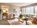 Bright living room featuring neutral decor, carpet floors, large windows and comfortable seating arrangements at 6130 Forest View Dr, Indianapolis, IN 46228