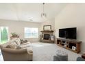 Bright living room with a stone fireplace and large windows at 6156 N Cedarwood Dr, McCordsville, IN 46055