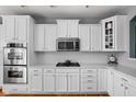 Bright kitchen with white cabinets, stainless steel appliances, and quartz countertops at 675 Greenford N Trl, Carmel, IN 46032