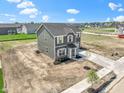 An elevated view showing the two-story home with light gray siding and white trim in a suburban neighborhood at 7167 Finley Creek Dr, Whitestown, IN 46075