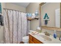 Traditional bathroom features decorative shower curtain, vanity with sink, and framed mirror at 7714 Black Walnut Dr, Avon, IN 46123