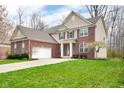 A beautiful two-story brick home with a well-manicured lawn and attached two car garage at 7714 Black Walnut Dr, Avon, IN 46123