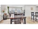 Open-concept dining room with a large table, chairs, and views into the cozy living area at 8546 Strabet Dr, Pendleton, IN 46064