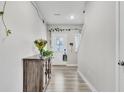 Bright entryway with light-colored wood floors, white walls, and greenery accents at 8546 Strabet Dr, Pendleton, IN 46064