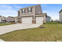 Charming two-story home with three car garage and manicured lawn, perfect for families at 8546 Strabet Dr, Pendleton, IN 46064