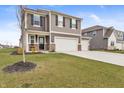 Inviting two-story home with a three-car garage, well-maintained lawn, and lovely curb appeal at 8546 Strabet Dr, Pendleton, IN 46064