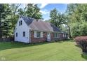 Quaint brick and siding home with a well-maintained lawn and traditional curb appeal at 8553 Broadway St, Indianapolis, IN 46240