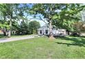 A long concrete driveway leading to a cozy home nestled among mature trees and green lawns at 8553 Broadway St, Indianapolis, IN 46240